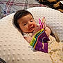 baby, bed, blanket, child, colorful, comfort, cozy, curious, cute, fabric_book, indoors, infant, pattern, person, pillow, plaid, playing, resting, soft_texture, young_child