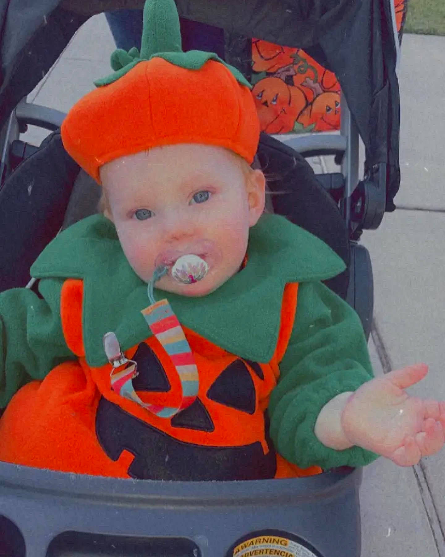 Lynleigh is registered to the contest to win money with this photo: baby, baby_carriage, baby_products, baby_toddler_clothing, baseball_cap, cap, car_seat, chair, child, costume, costume_hat, fashion_accessory, fun, head, headwear, orange, people, person, sitting, toddler