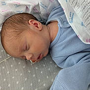 Archie joined the competition — help win amazing prizes! newborn, baby, sleeping, blanket, onesie, face, head, infant, soft, cozy, plush, medical_tube, bed, closeup, peaceful, child, person, indoors, cute, resting