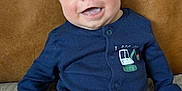 Archie joined the competition — help win amazing prizes! baby, smiling, onesie, blue_clothing, infant, cute, portrait, sitting, happy, face, child, indoor, leather_background, soft_surface, young_child, eyewear_absent, short_hair, buttoned_clothing, closeup, human