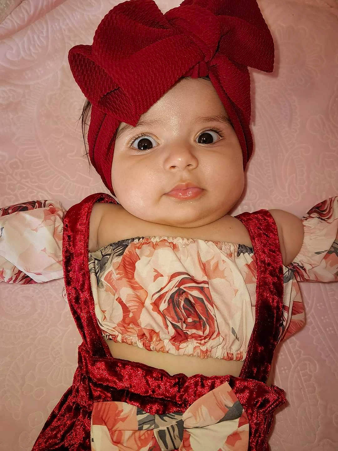 Stella is registered to the contest to win money with this photo: baby, baby_toddler_clothing, cheek, costume_hat, day_dress, dress, embellishment, eye, eyelash, fedora, hat, head, headwear, lip, one_piece_garment, pattern, person, pink, skin, sleeve