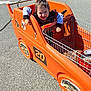 Nova is registered to the contest to win money with this photo: alloywheel, baby, car, carwheel, city, face, head, machine, outdoors, person, photography, portrait, road, shoppingcart, spoke, street, transportation, urban, vehicle, wheel