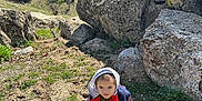 Nova joined the competition — help win amazing prizes! boy, child, clothing, face, footwear, grass, hat, head, male, nature, outdoors, person, photography, plant, portrait, rock, shoe, sitting, soil, wilderness
