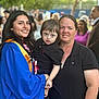 Nova is registered to the contest to win money with this photo: blue_gown, casual_clothing, celebration, child, daylight, event, family, gathering, graduation, group, happy, holding, nature, orange_sash, outdoor, park, people, portrait, smile, woman