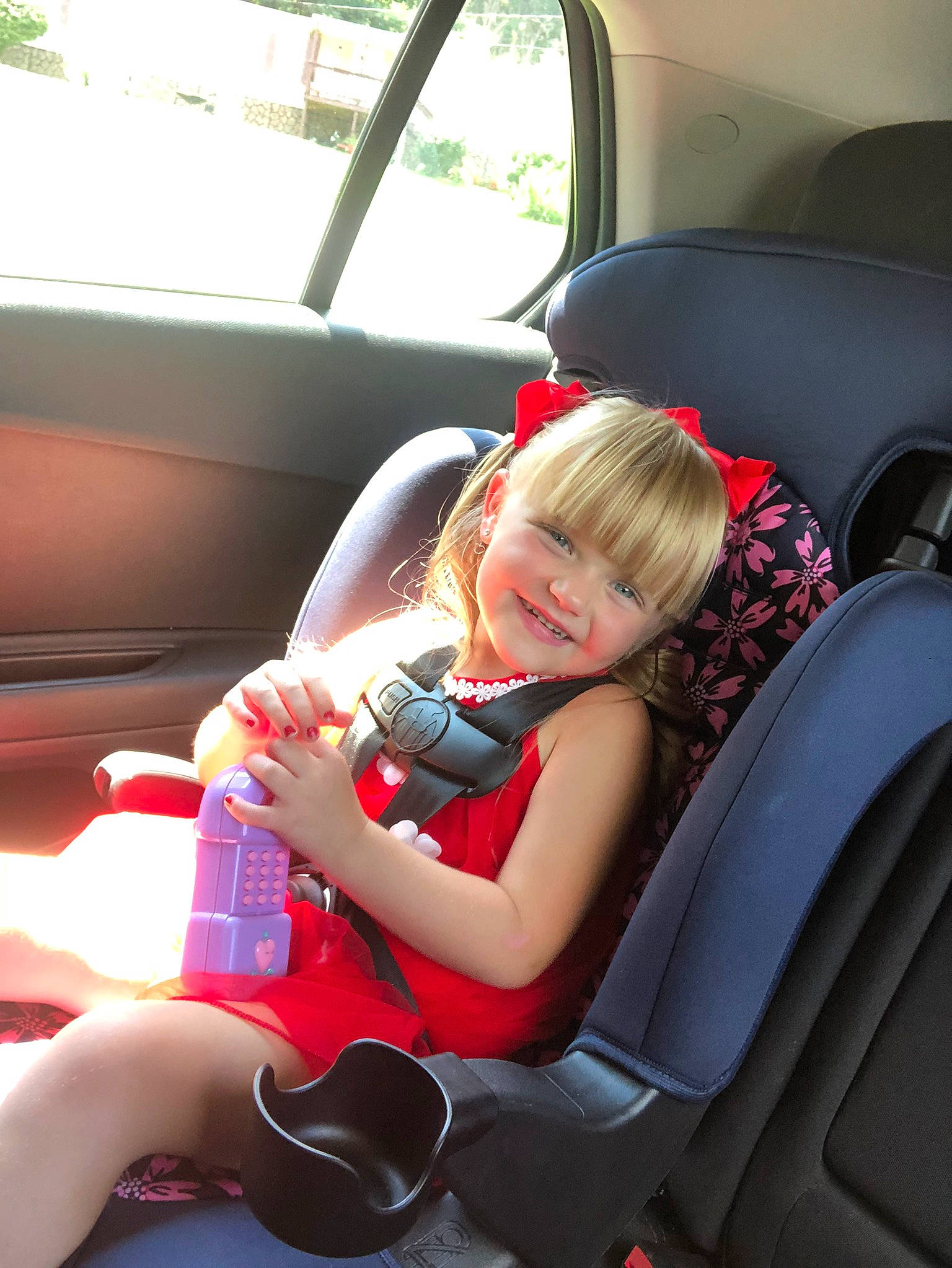 Kendall is registered to the contest to win money with this photo: auto_part, automotive_design, automotive_exterior, car, car_seat, car_seat_cover, child, comfort, dress, head_restraint, joy, motor_vehicle, person, personal_luxury_car, seat_belt, smile, steering_part, steering_wheel, toddler, vehicle