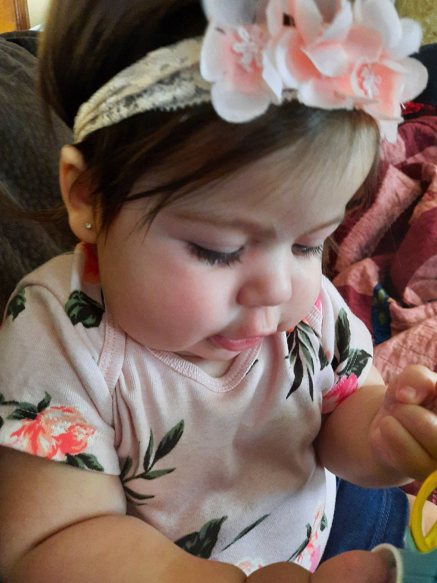 Railyn is registered to the contest to win money with this photo: baby, brown_hair, cheek, child, fashion_accessory, flower, hair, hair_accessory, hand, headband, headgear, headpiece, person, petal, pink, plant, skin, toddler