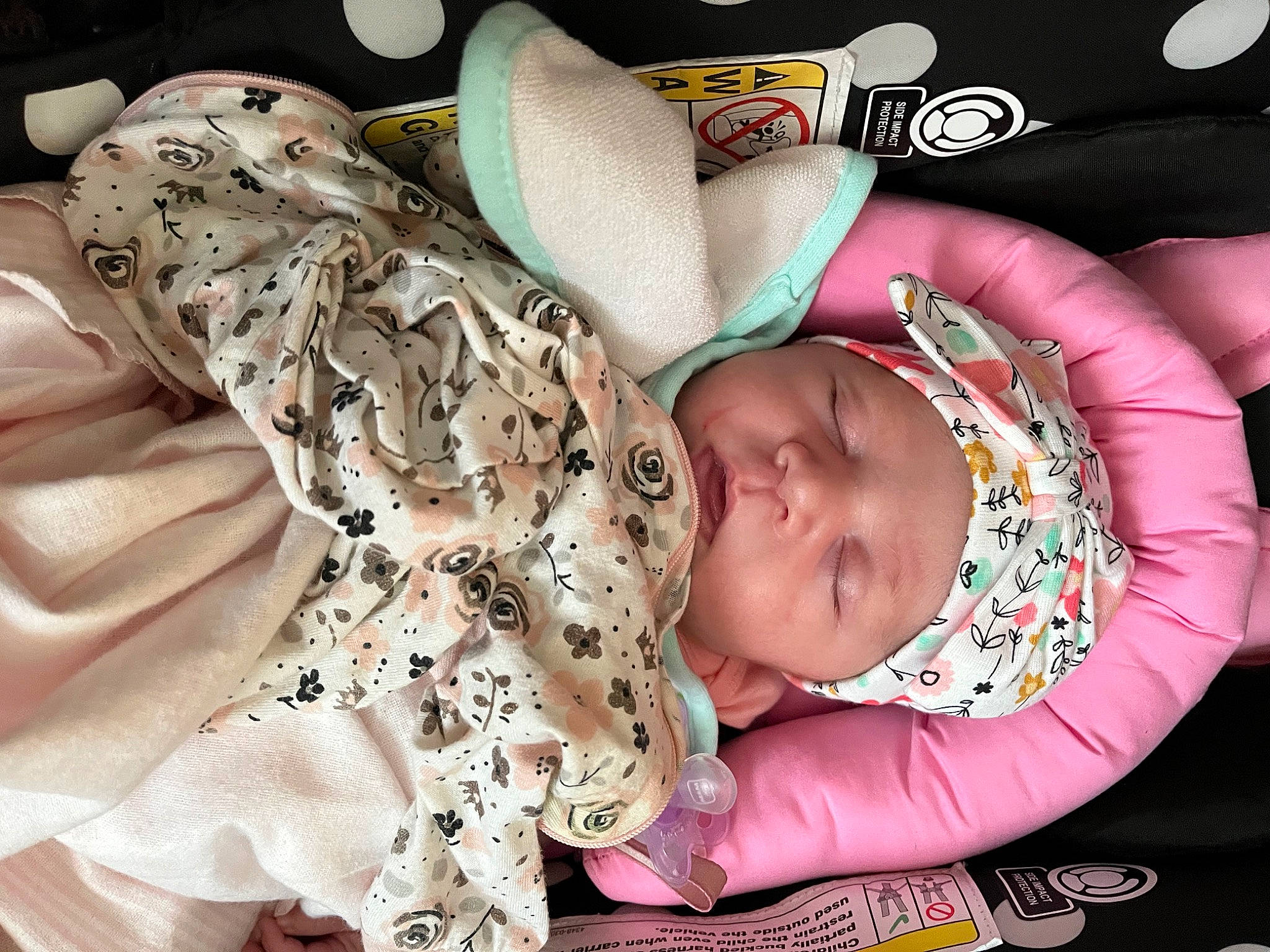 Aniya is registered to the contest to win money with this photo: arm, baby, baby_products, baby_sleeping, baby_toddler_clothing, cheek, comfort, facial_expression, finger, head, headgear, headwear, human_body, linens, pattern, person, photograph, pink, skin, sleeve