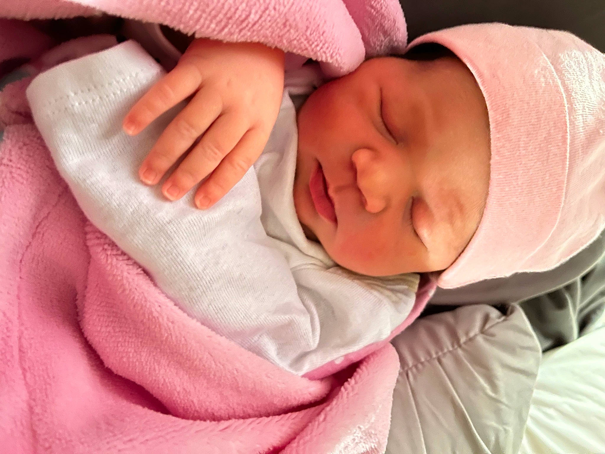 Aniya is registered to the contest to win money with this photo: baby, baby_sleeping, baby_toddler_clothing, cheek, comfort, eye, eyebrow, finger, gesture, hand, head, headwear, iris, lip, mouth, nose, person, pink, red, skin