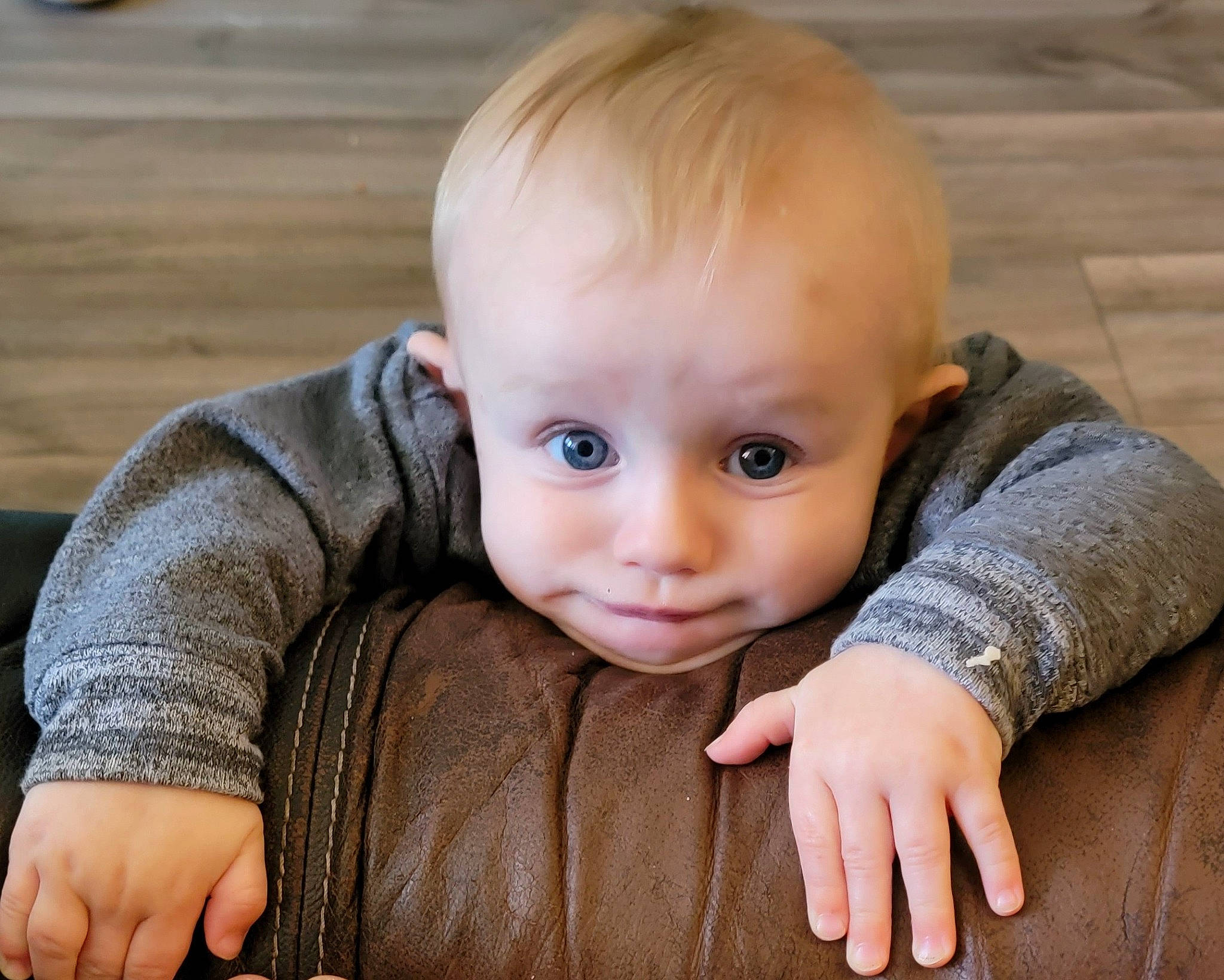 Trevor is registered to the contest to win money with this photo: baby, baby_toddler_clothing, cheek, eye, finger, flash_photography, floor, flooring, gesture, grass, happy, hardwood, head, iris, nose, person, skin, sleeve, smile, toddler
