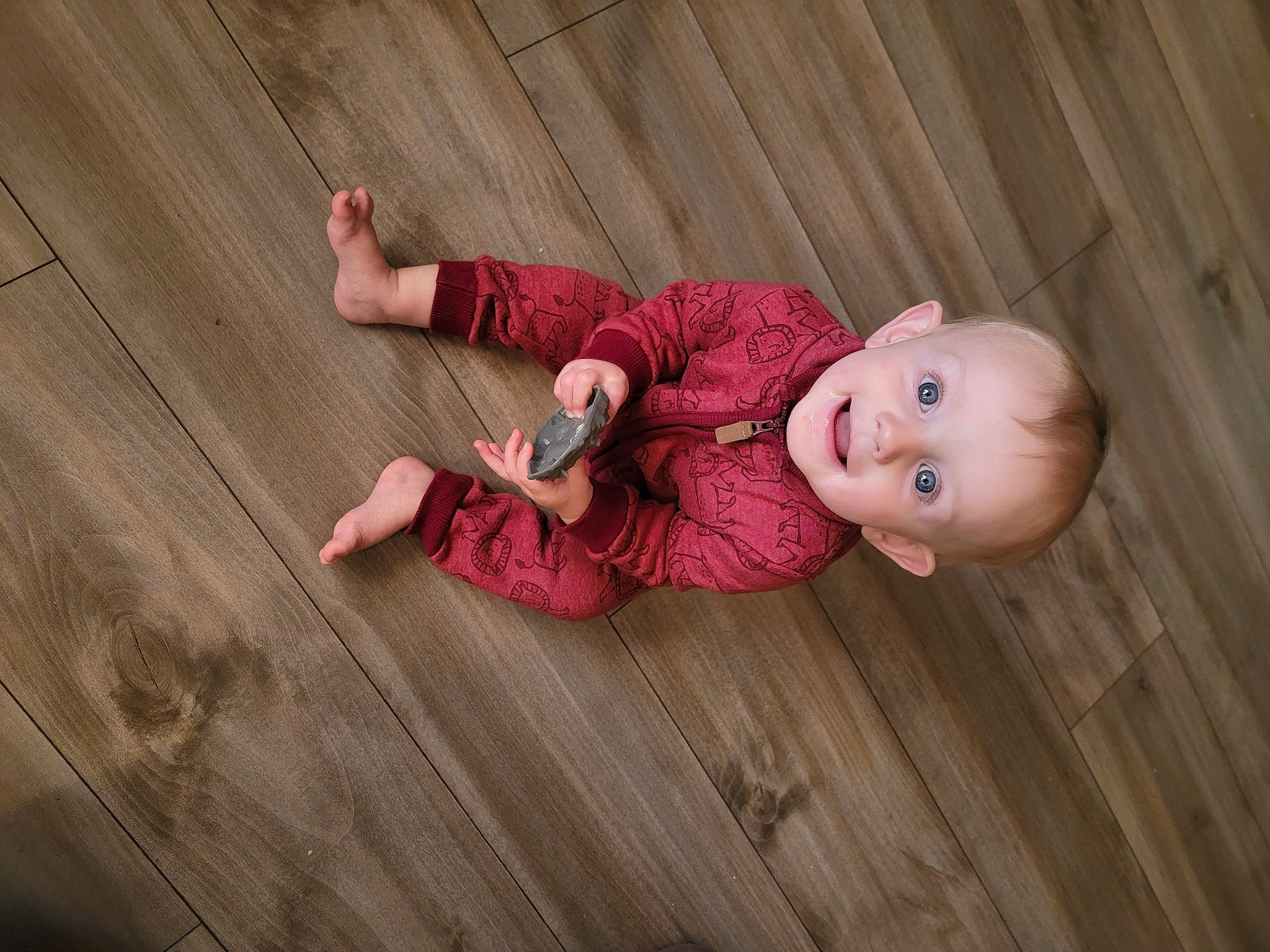 Trevor joined the competition — help win amazing prizes! baby, baby_toddler_clothing, cheek, child, floor, flooring, foot, grass, hardwood, human_body, joy, nose, pattern, person, pink, sitting, skin, sleeve, smile, toddler