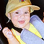 baby, child, smiling, cap, mickey_mouse, yellow_clothing, car_seat, seatbelt, happy, cute, face, tongue_out, infant, portrait, closeup, baby_hand, headwear, childhood, safety, joy