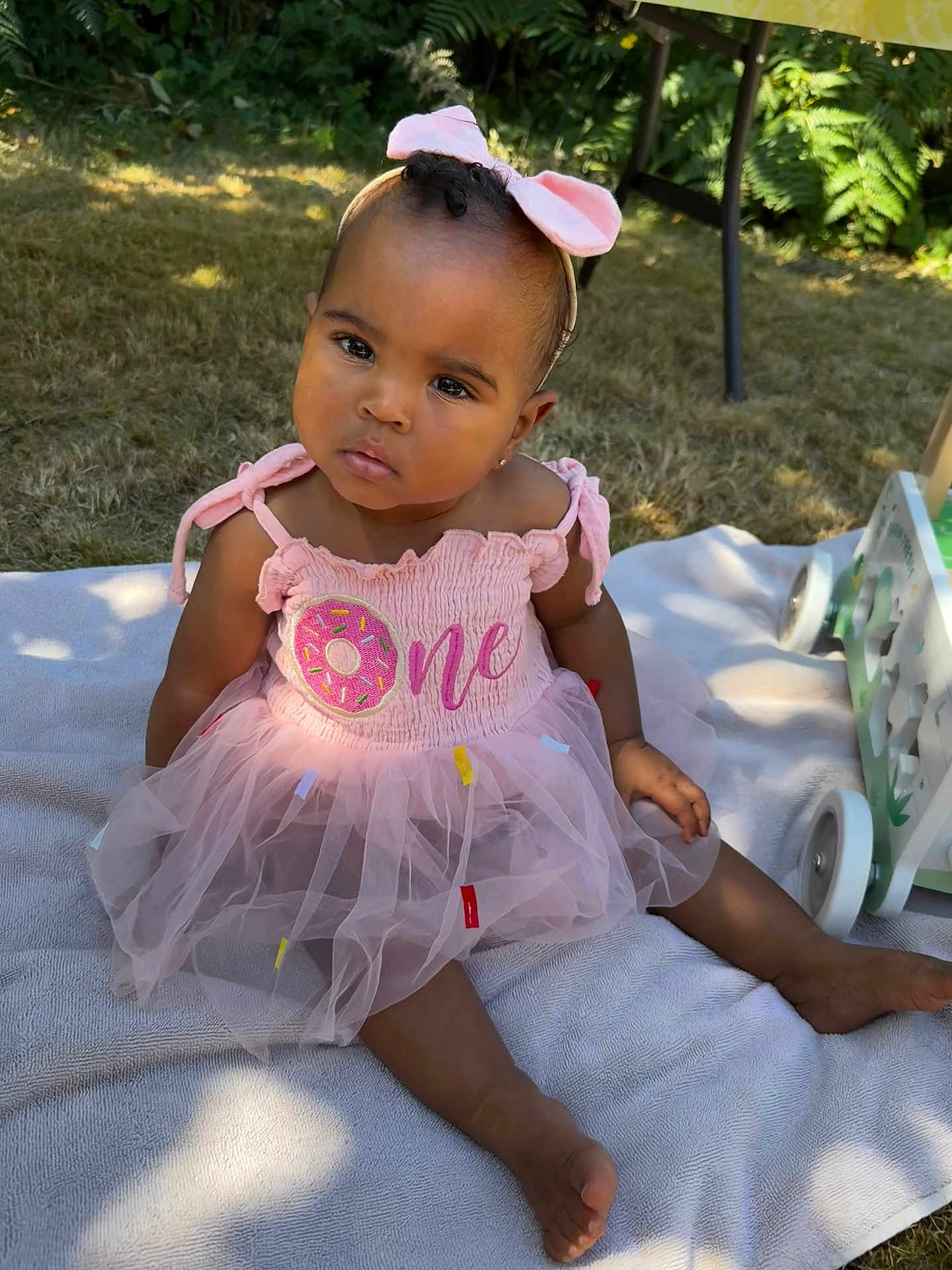 Kycee joined the competition — help win amazing prizes! baby, child, pink_dress, bow, headband, outdoor, grass, blanket, sunlight, tutu, sitting, cute, curious, portrait, toddler, greenery, soft_light, summer, toy, feet
