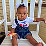 baby, child, infant, denim_overalls, white_headband, plush_toy, barefoot, porch, wooden_chair, casual_clothing, outdoor, cute, expression, person, sitting, skin, curly_hair, toy, summer, relaxed