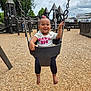 Kycee joined the competition — help win amazing prizes! baby, child, swing, playground, wood_chips, smiling, happy, outdoor, person, clothing, legs, feet, trees, wooden_play_structure, sky, cloudy, daytime, fun, cute, girl