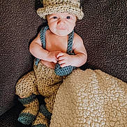 Bentley is registered to the contest to win money with this photo: baby, baby_toddler_clothing, cap, child, comfort, costume_hat, eye, fashion_accessory, flash_photography, grass, head, headband, headpiece, human_leg, knit_cap, pattern, skin, sleeve, toddler, wood