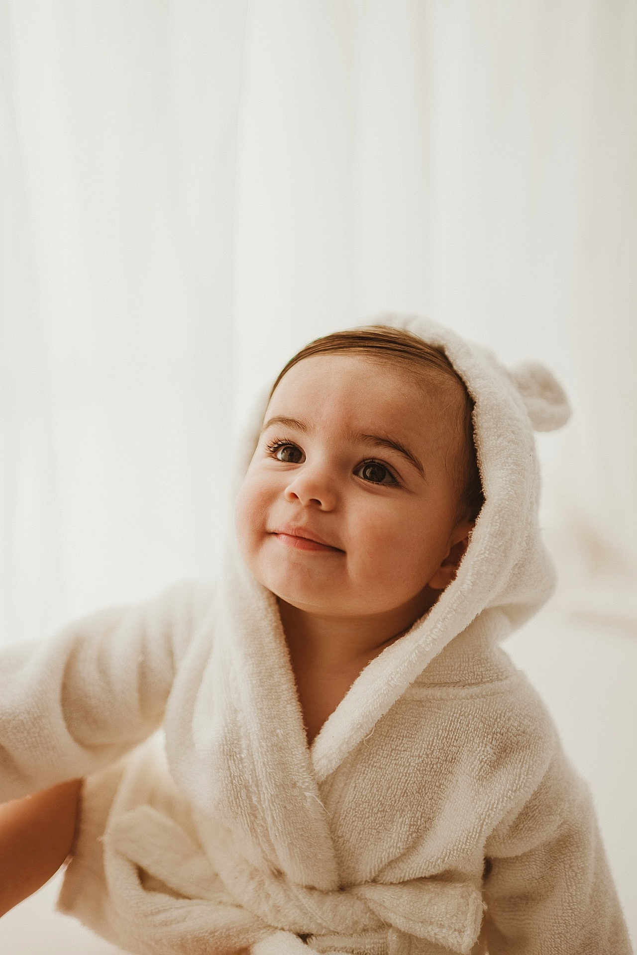 Arthur is registered to the contest to win money with this photo: baby, child, hooded_robe, white_robe, smile, cute, soft_light, portrait, indoor, face, eyes, infant, warm, cozy, expression, toddler, adorable, skin, young_child, apparel