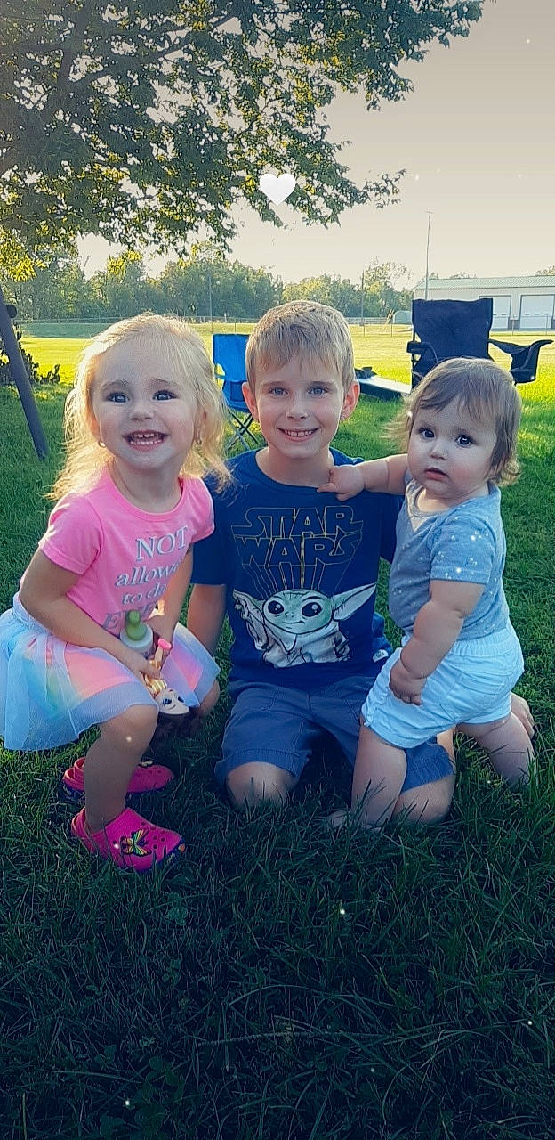 Kristian is registered to the contest to win money with this photo: baby_toddler_clothing, botany, cool, face, facial_expression, grass, happy, iris, joy, leisure, nature, people_in_nature, person, pink, plant, shorts, skin, smile, standing, sunlight