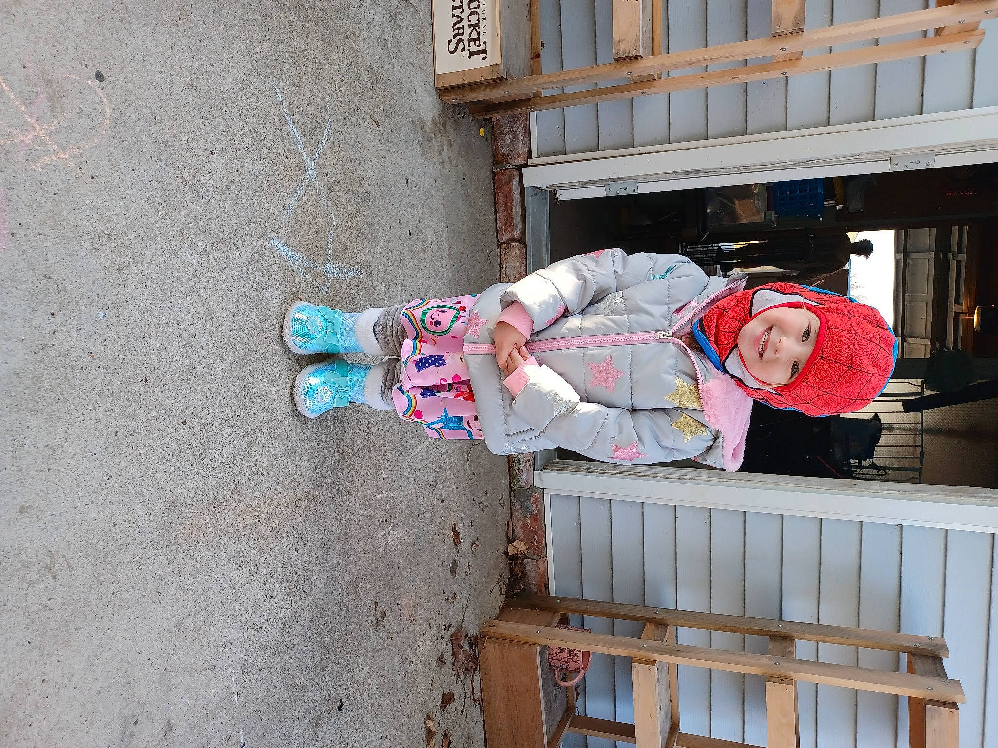 Peyton is registered to the contest to win money with this photo: composite_material, concrete, headwear, joy, person, street_fashion, toddler, walking_shoe, window