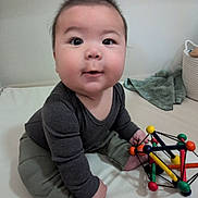 Henry joined the competition — help win amazing prizes! baby, child, toy, colorful, indoor, sitting, curious, soft_surface, blanket, basket, clothing, long_sleeve, pants, foot, face, head, hair, play, infant, cute