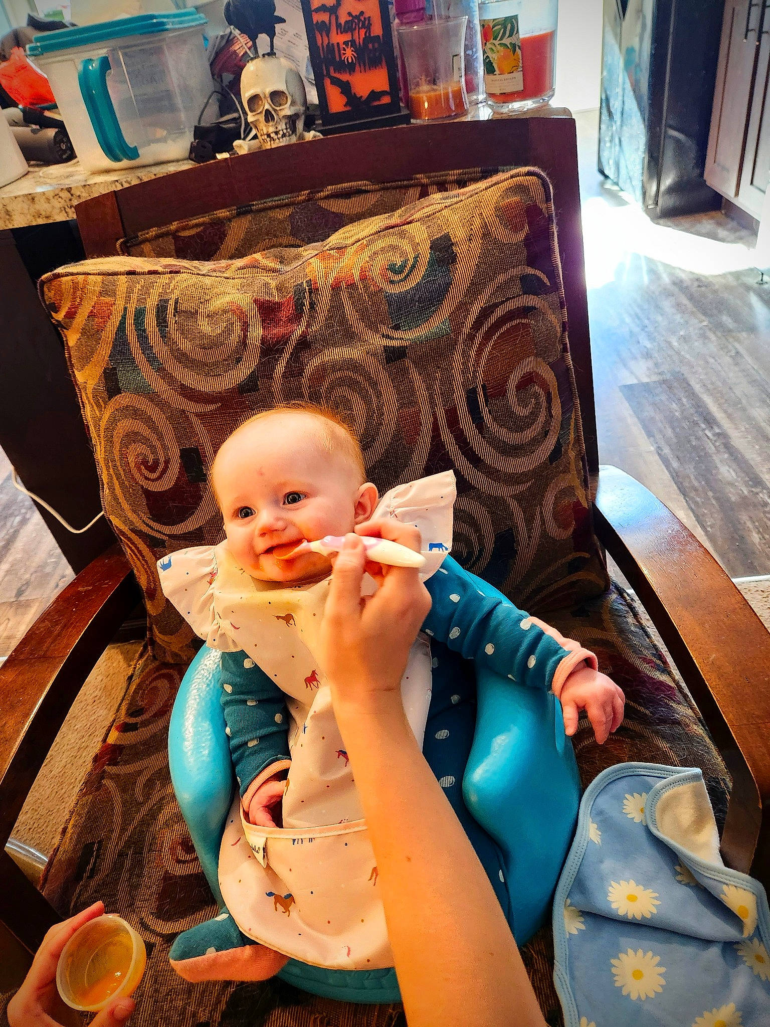 Kinsleigh is registered to the contest to win money with this photo: baby, baby_products, baby_toddler_clothing, blue, chair, child, comfort, couch, event, flooring, fun, hardwood, joy, leisure, living_room, nail, orange, person, room, sitting
