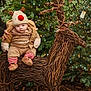 Elijah is registered to the contest to win money with this photo: baby, reindeer_hat, winter_clothing, twinkling_lights, christmas_tree, ivy, twig_reindeer, outdoor, festive, holiday, cozy, cute, greenery, child, decorative_reindeer, nature, seasonal, smiling, warm_clothing, christmas