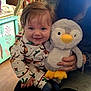 Elijah is registered to the contest to win money with this photo: baby, child, childhood, clothing, cozy, cuddly, cute, floor, furniture, hand, happy, home, indoor, pajamas, penguin, person, plush_toy, portrait, smiling, toy