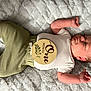 Jasper is registered to the contest to win money with this photo: arm, baby, baby_sleeping, baby_toddler_clothing, comfort, facial_expression, finger, hand, headgear, human_body, joint, leg, mammal, mouth, nose, skin, sleeve, textile, vertebrate, wood