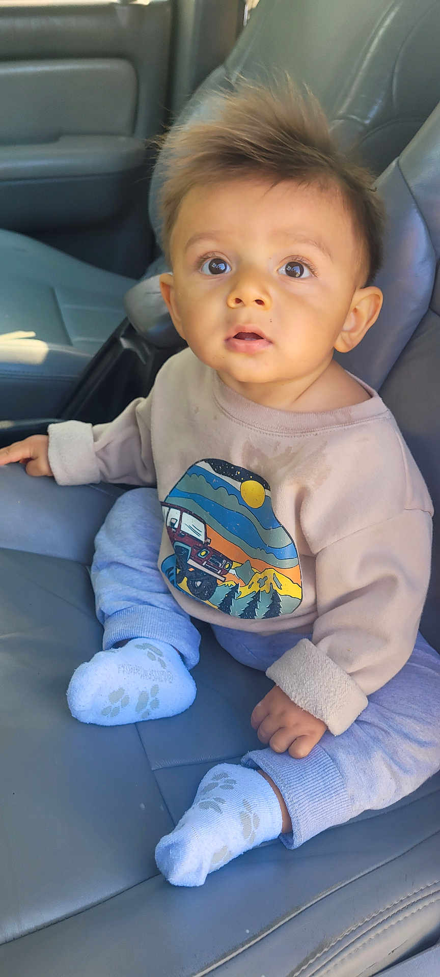 Hugo joined the competition — help win amazing prizes! baby, child, infant, car_seat, clothing, sweater, socks, curly_hair, big_eyes, portrait, indoor, seat, cute, casual, looking_up, person, young, human, sitting, expression