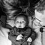 Ezekiel participe au concours pour gagner de l'argent avec cette photo : baby, bow_tie, shirt, blanket, people, family, black_and_white, portrait, infant, hands, adult, watch, close_up, smiling, lying_down, cute, intimate, together, love, happy