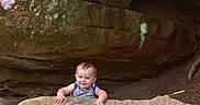 Gracen joined the competition — help win amazing prizes! baby, child, rock, cave, smile, peeking, outdoor, nature, face, person, adventure, curious, stone, young, exploration, happy, hands, head, infant, casual