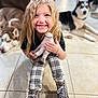 child, smiling, blonde_hair, plaid_leggings, black_boots, doll, indoor, tiled_floor, dog, husky, pet, happy, seated, toy, casual_clothing, long_hair, floor, cute, cozy, portrait