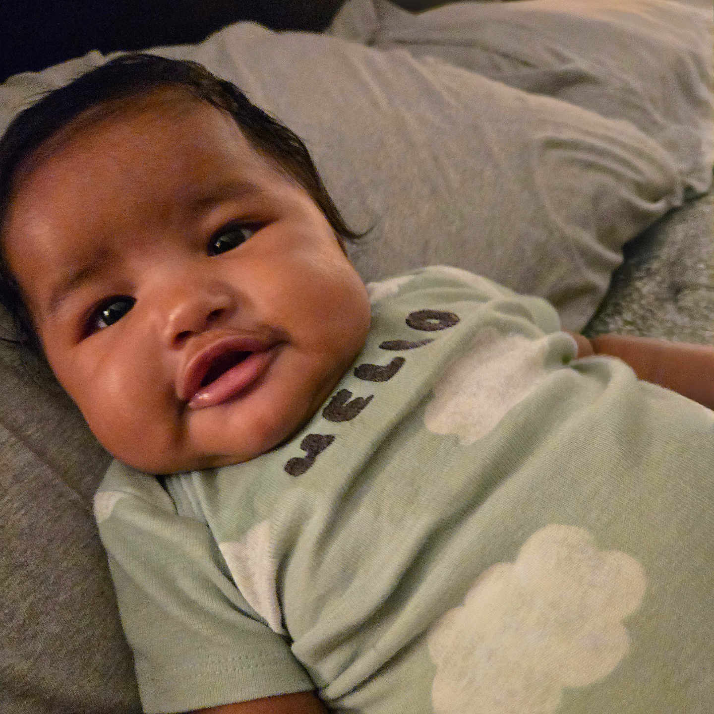 Genesis is registered to the contest to win money with this photo: baby, bed, bedroom, blanket, clothing, couch, cushion, face, furniture, happy, head, homedecor, indoors, newborn, person, photography, portrait, room, smile, t_shirt