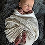 newborn, baby, swaddled, blanket, feet, sleeping, infant, soft_texture, cozy, peaceful, resting, wrapped, cuddly, portrait, child, human, skin, head, hands, toes