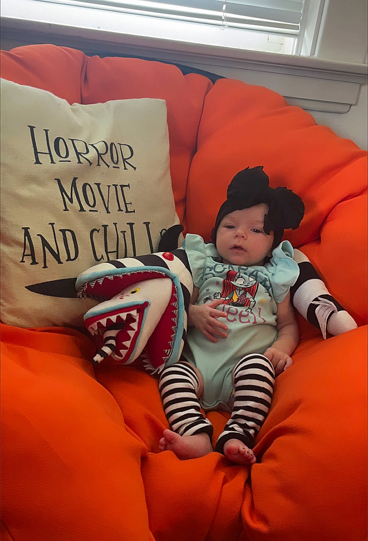 Alice is registered to the contest to win money with this photo: baby, baby_toddler_clothing, cap, carmine, chair, child, comfort, couch, font, foot, happy, headwear, linens, orange, person, product, room, sitting, t_shirt, textile