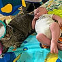 Wesley is registered to the contest to win money with this photo: baby, cat, playmat, toy, mirror, tabby_cat, infant, colorful, indoor, animal, child, relaxed, cute, soft_toys, floor, carpet, clothing, face, lying_down, curious