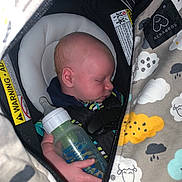 Wesley joined the competition — help win amazing prizes! baby, infant, sleeping, bottle, car_seat, blanket, hand, face, child, clothing, comfort, cute, indoors, peaceful, rest, toddler, young_child, soft_lighting, close_up, protective_gear