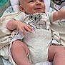 Wesley is registered to the contest to win money with this photo: baby, infant, onesie, koala_print, baby_seat, blanket, smiling, reaching, toy, mickey_mouse, cushion, foot, hand, face, head, outdoor, happy, closeup, person, child