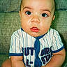 Michael joined the competition — help win amazing prizes! baby, child, infant, person, face, couch, clothing, striped, onesie, sitting, cute, curious, expression, indoor, furniture, skin, head, eyes, hands, portrait