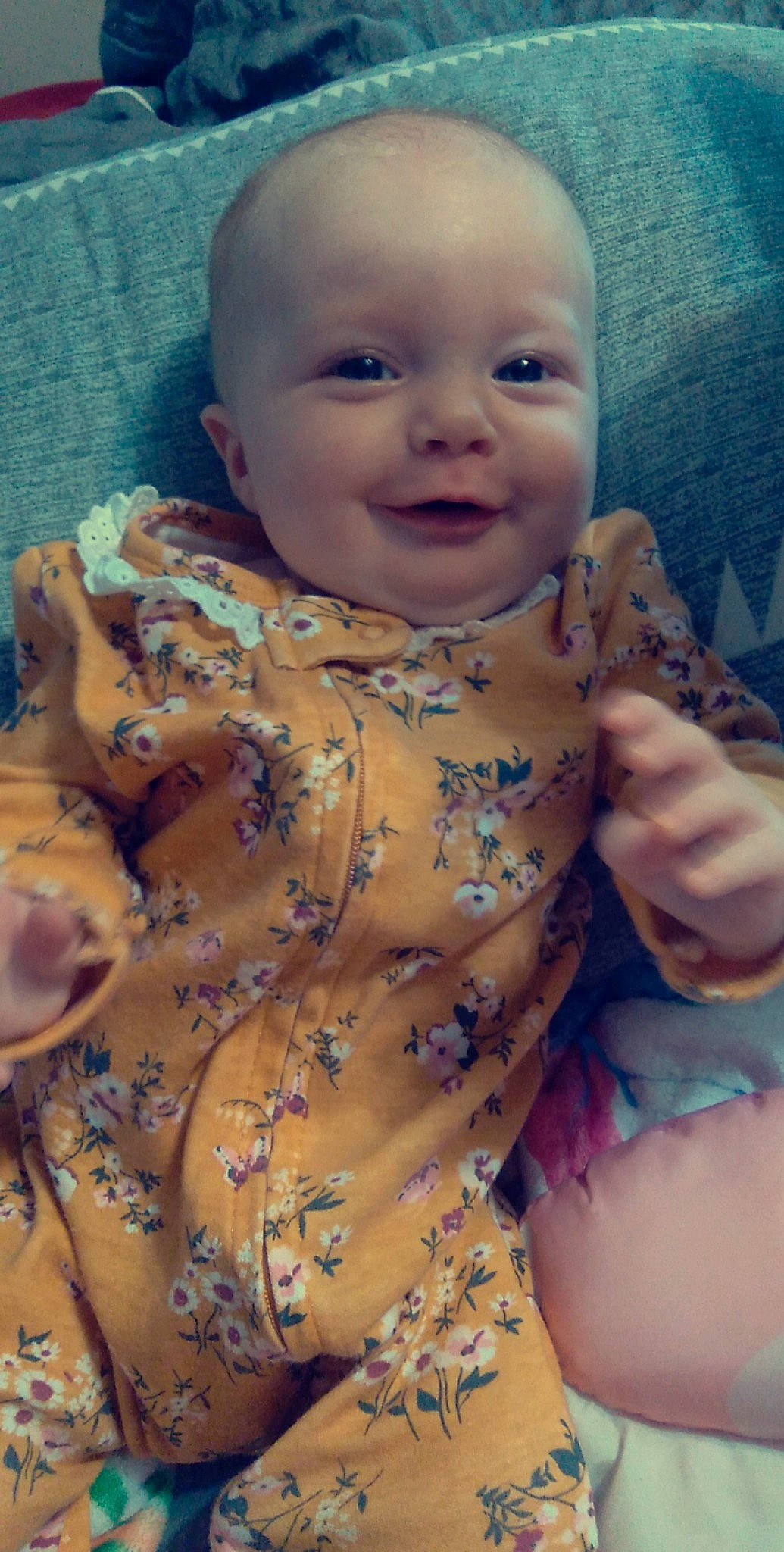 Carrie is registered to the contest to win money with this photo: arm, baby_toddler_clothing, cheek, chin, eye, eyebrow, face, facial_expression, hairstyle, head, human_body, lip, mouth, neck, nose, person, skin, sleeve, smile, stomach