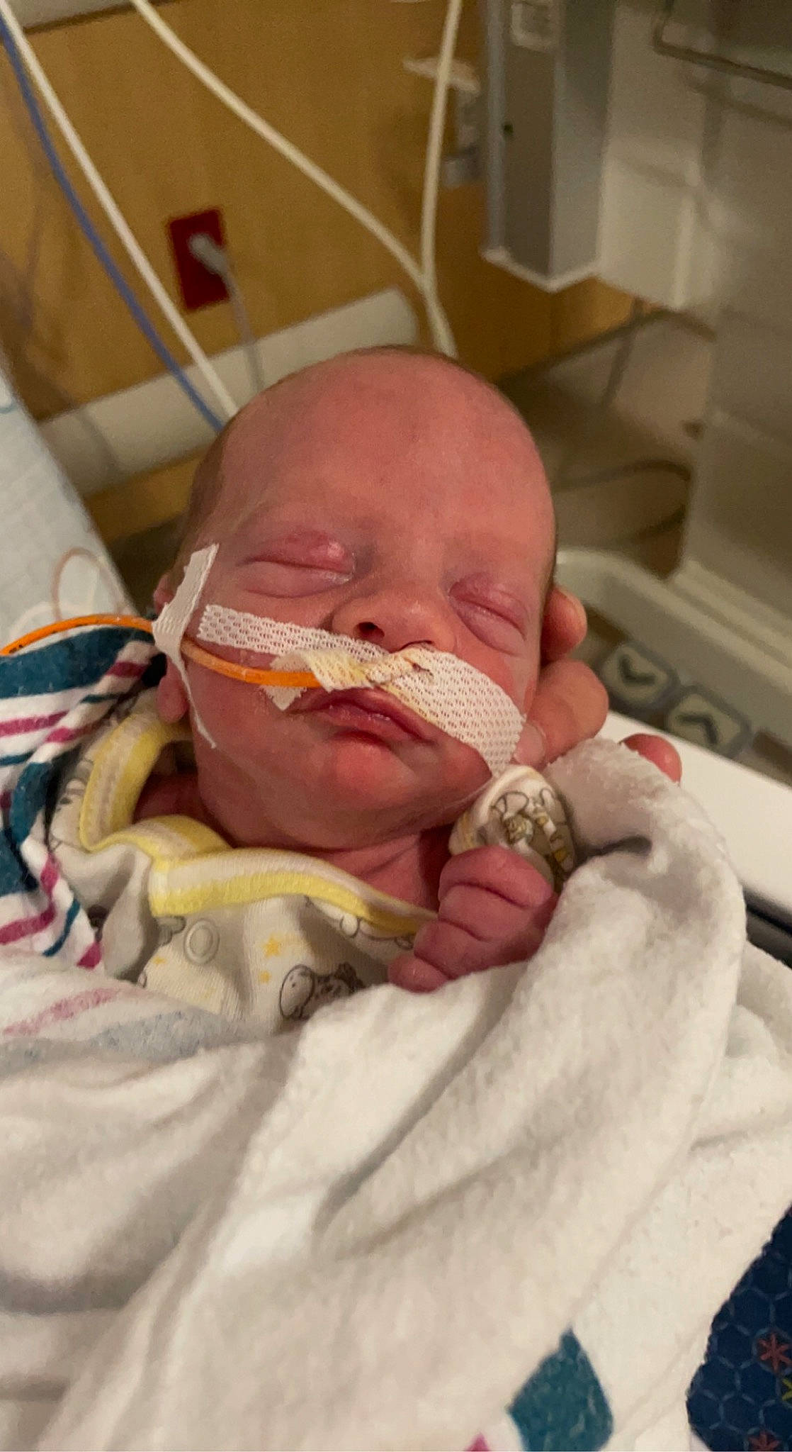 Adonis is registered to the contest to win money with this photo: baby, cheek, child, childbirth, comfort, event, eye, hand, health_care, hospital, linens, medical, medical_equipment, medical_procedure, patient, pediatrics, person, service, skin, thumb