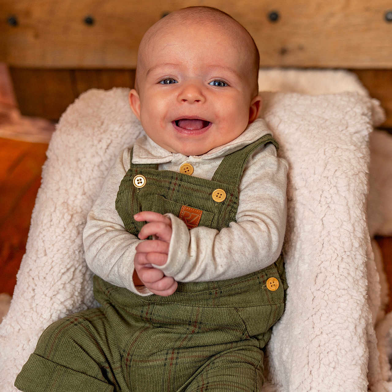 Everett is registered to the contest to win money with this photo: baby, babylaughing, bodypart, clothing, couch, face, finger, furniture, hand, happy, hardwood, head, jeans, pants, person, photography, portrait, sitting, smile, wood
