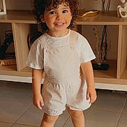 Ayane a rejoint le concours — aidez-le/la à gagner de superbes lots ! child, curly_hair, cute, decor, furniture, happy, home, indoor, overalls, person, smile, smiling, standing, television, tile_floor, toddler, tshirt, white_shoes, wooden_shelf, young