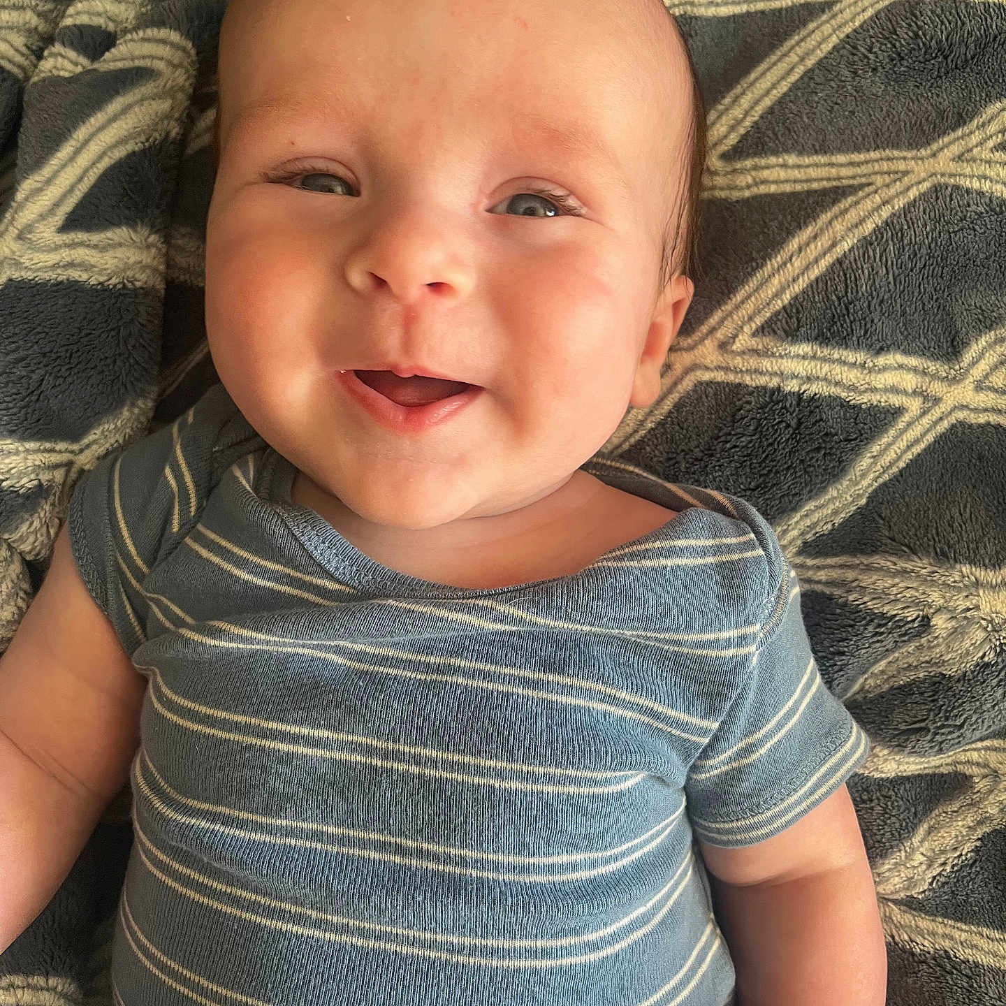 Colton is registered to the contest to win money with this photo: baby, babylaughing, bodypart, clothing, cushion, face, furniture, happy, head, homedecor, laughing, mouth, newborn, person, photography, portrait, shirt, smile, t_shirt, teeth
