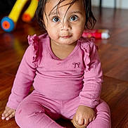Anvi joined the competition — help win amazing prizes! background_blur, big_eyes, casual, child, childhood, curious, cute, expression, floor, hair, home, indoors, pink_clothing, playtime, portrait, sitting, toddler, toy, tricycle, wooden_floor