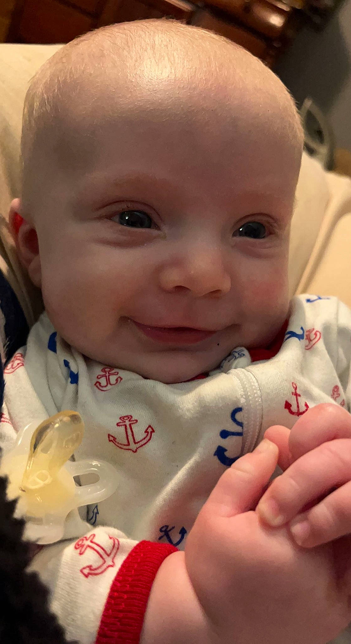 Greyson is registered to the contest to win money with this photo: baby_toddler_clothing, cheek, chin, dress, eye, eyebrow, facial_expression, gesture, hairstyle, hand, happy, human, iris, lip, mammal, mouth, neck, nose, person, skin