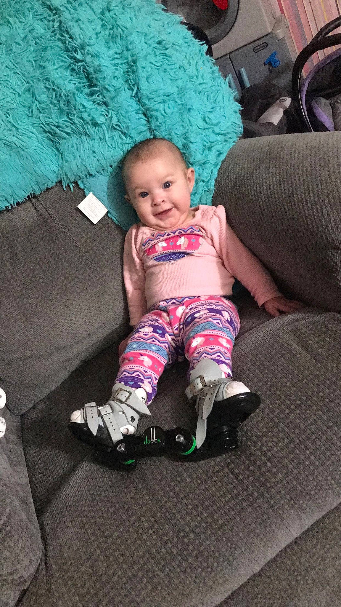 Karma is registered to the contest to win money with this photo: arm, baby, baby_toddler_clothing, comfort, couch, eye, finger, head, human_body, joy, knee, lap, leg, mouth, person, skin, sleeve, sock, t_shirt, textile