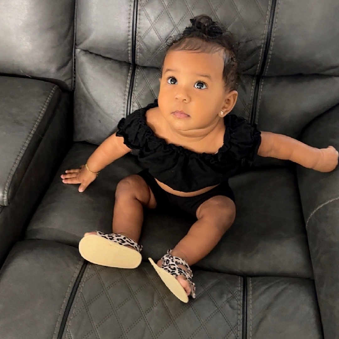 Sincerity is registered to the contest to win money with this photo: armchair, baby, bodypart, chair, clothing, couch, cushion, face, finger, footwear, furniture, hand, head, person, photography, portrait, sandal, shoe, sitting, toy