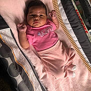 Nylah joined the competition — help win amazing prizes! baby, infant, pink_clothing, towel, blanket, playpen, soft_texture, cute, lying_down, indoor, child, newborn, person, closeup, portrait, sleepwear, cozy, adorable, small_hands, striped_socks