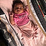 baby, infant, pink_clothing, towel, blanket, playpen, soft_texture, cute, lying_down, indoor, child, newborn, person, closeup, portrait, sleepwear, cozy, adorable, small_hands, striped_socks