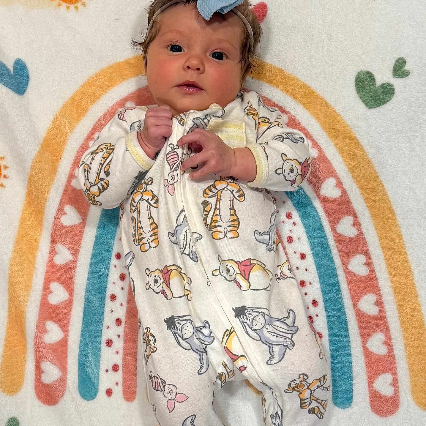 Conley joined the competition — help win amazing prizes! adorable, baby, blanket, blue_bow, child, colorful, cozy, cute, eeyore, heart_pattern, infant, lying_down, onesie, piglet, portrait, rainbow, soft_texture, sun_pattern, tigger, winnie_the_pooh